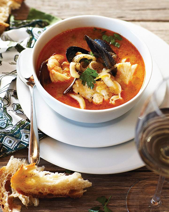 Bowl of bouillabaisse with crusty bread
