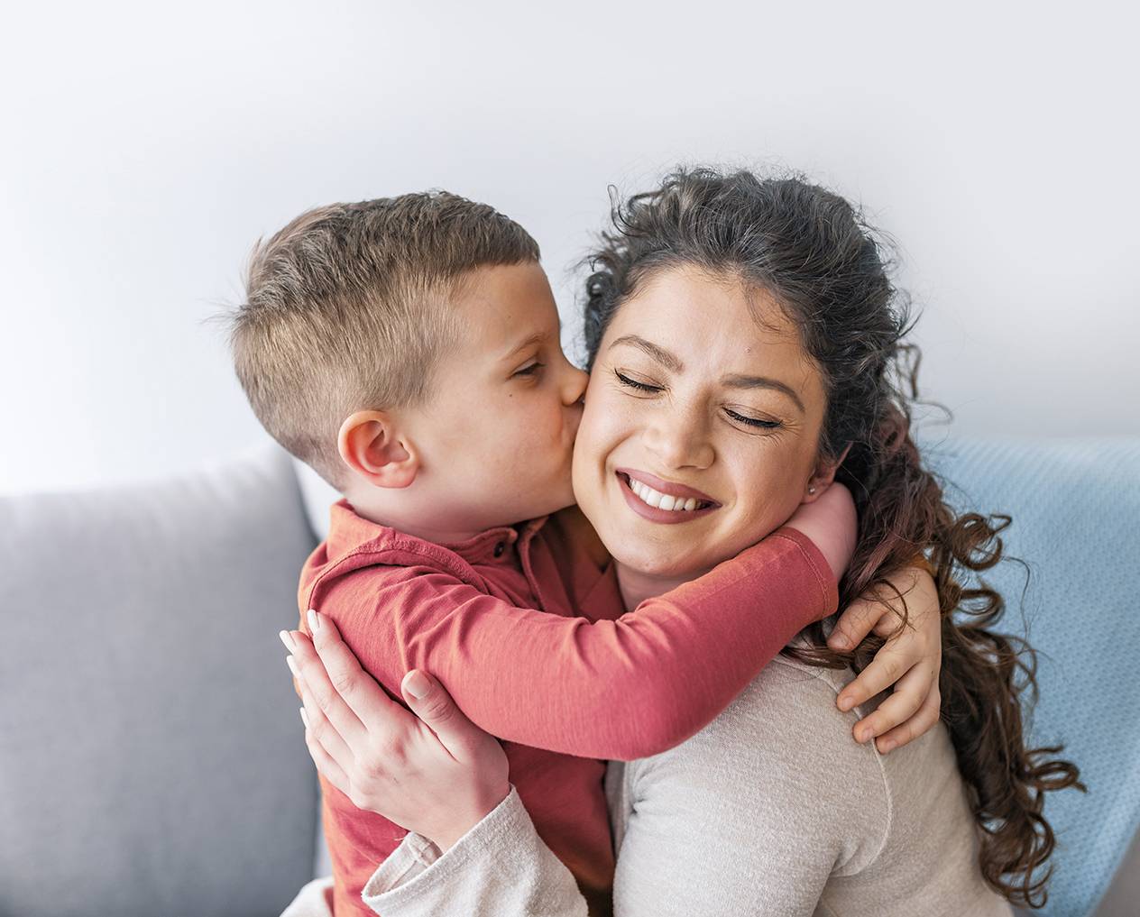 Son is kissing his mother.