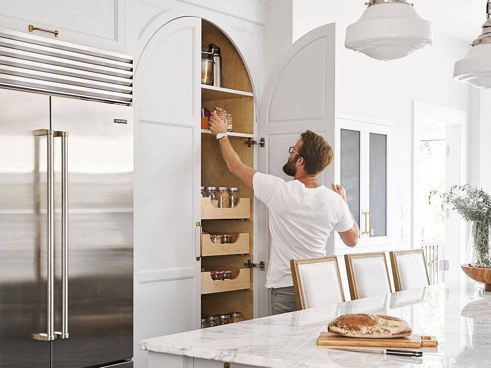 Joshua Lawrence reaching into a cabinet