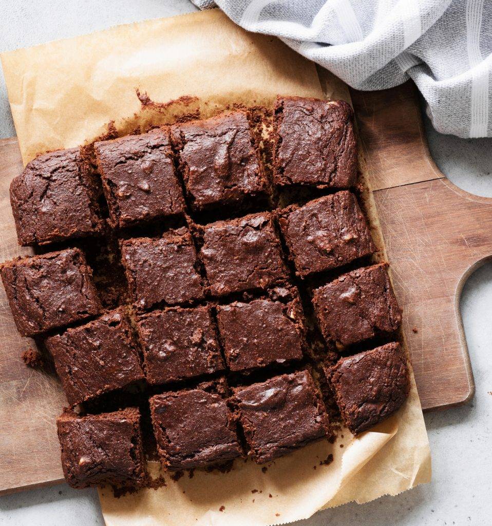 Chocolate brownie squares on cutting board.