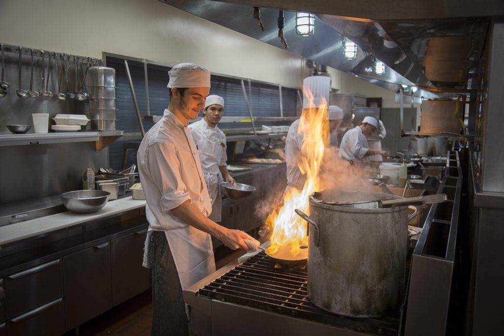 student cooking at Camosun College teaching kitchen