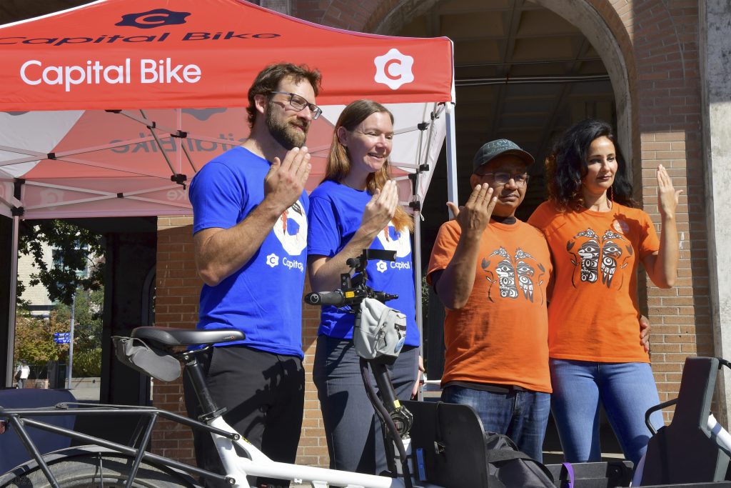 Adam Krupper and Sarah Frumento of Capital Bike stand alongside Eddy Charlie and Kristin Spray of Xe xe Smun eem-Victoria Orange Shirt Day at the Fall Go By Bike Week Launch event at Centennial Square on September 1st.