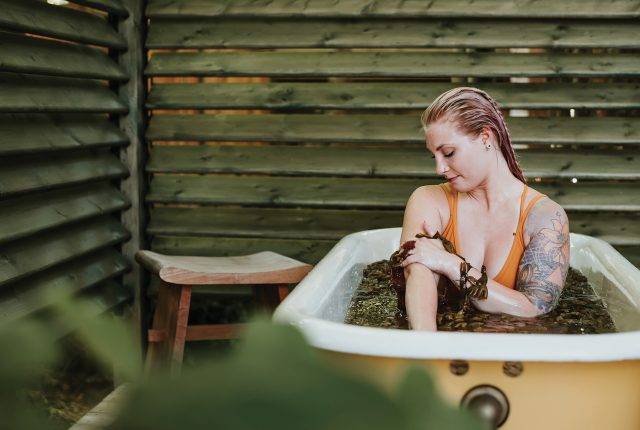 A woman takes a seaweed bath