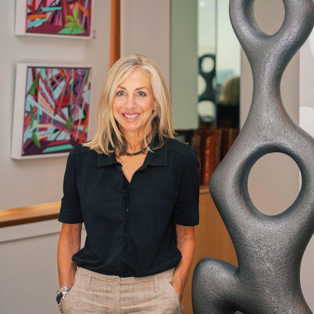 Leah McDiarmid in her new Tofino Gallery of Contemporary Art next to a sculpture by Birgit Piskor.