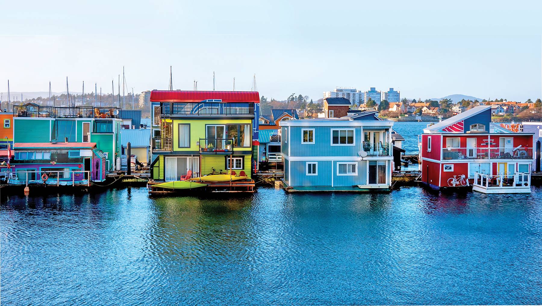 Colorful house boats anchored by Fisherman’s wharf Victoria