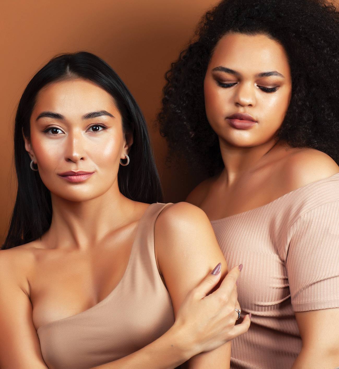 young pretty asian, caucasian, afro woman posing cheerful together on brown background, lifestyle diverse nationality people concept