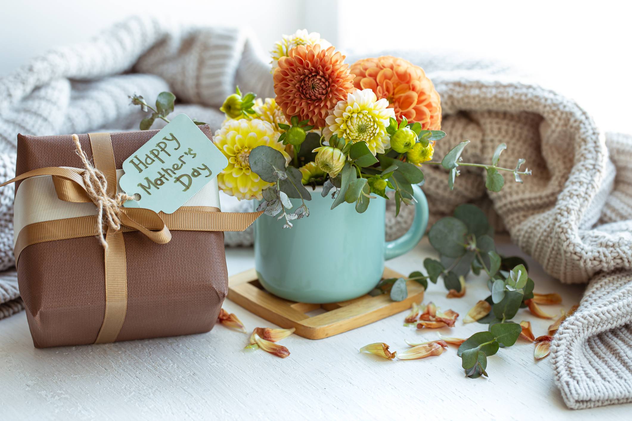 Spring composition for mother’s day with a gift and chrysanthemum flowers.
