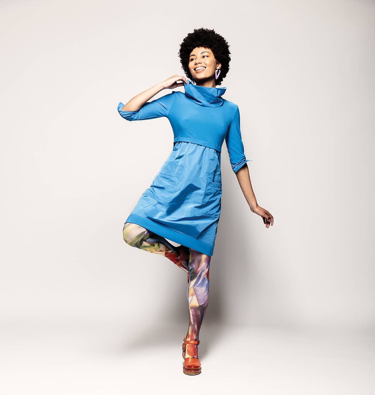 Blue cowl-neck dress by Joseph Ribkoff available at Adventure Clothing. Tights by Tabbisocks availa-ble at De Mode En Vogue. Sandals by A.S. 98, available at Waterlily Shoes. Earrings, stylist’s own.