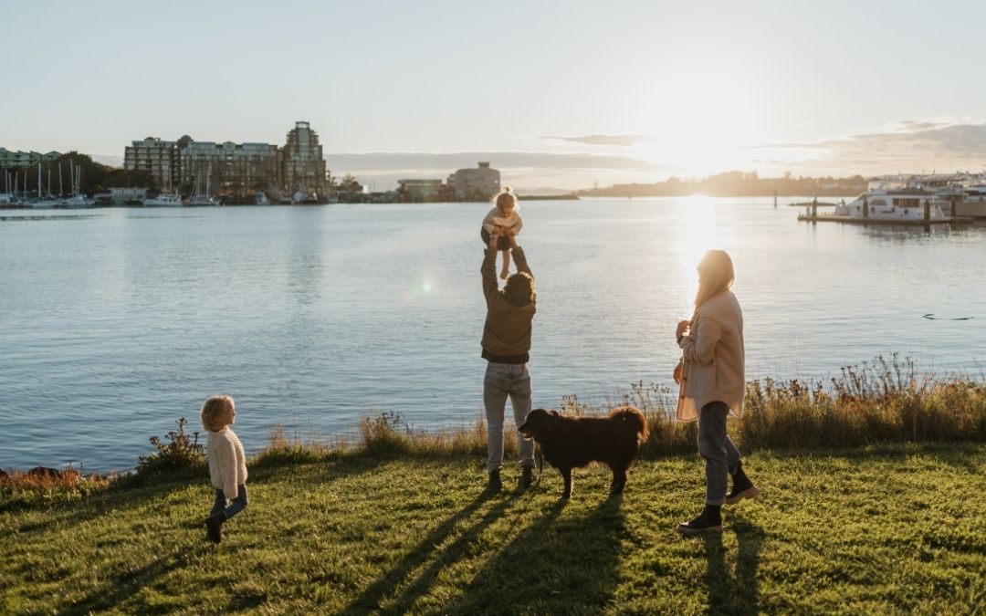 family enjoying Victoria BC sunset on the water